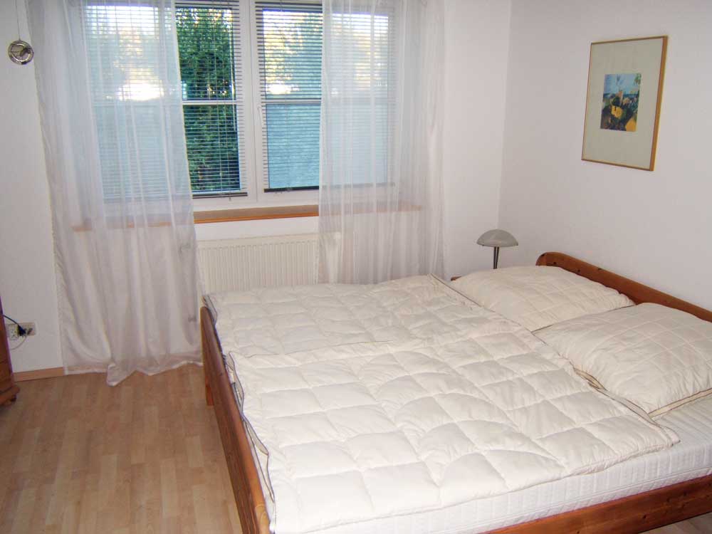 Schlafzimmer mit einem großen Doppelbett, Kleiderschrank und ein kleiner Fernseher